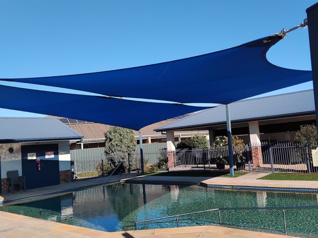 multiple shade sails over pool area